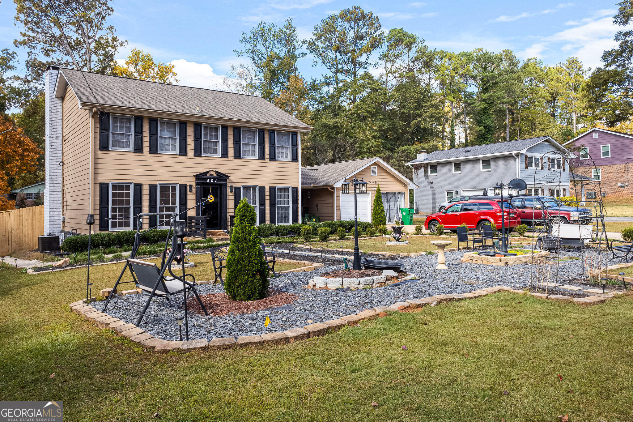 a view of a house with backyard and sitting area