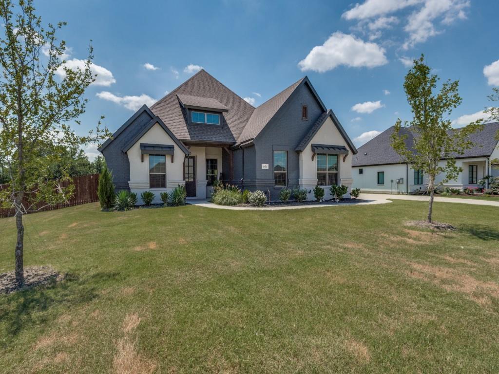 a front view of house with yard and green space