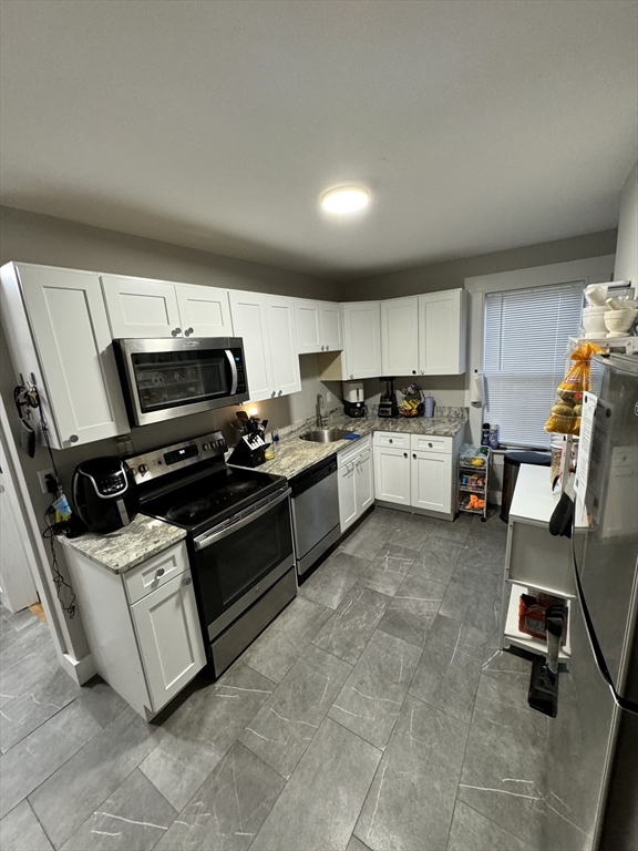 a kitchen with a stove a microwave and a refrigerator