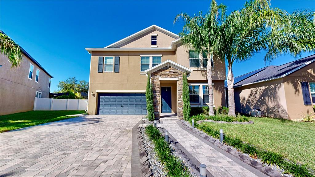 a front view of a house with a yard and garage