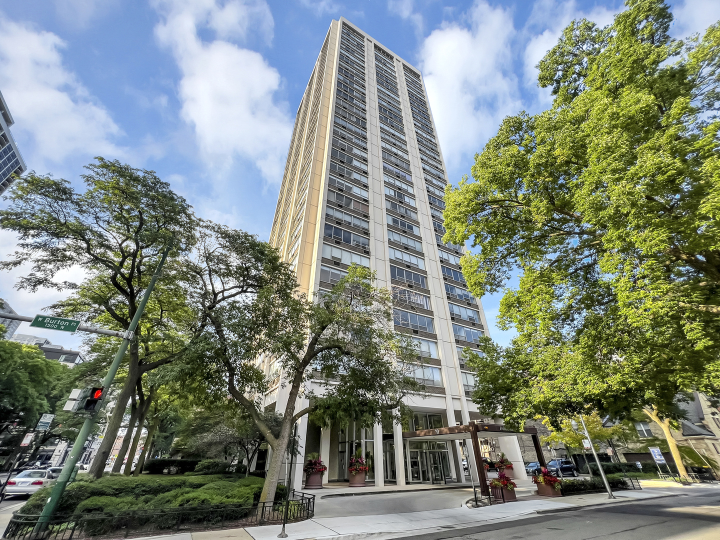 a view of a tall building next to a road