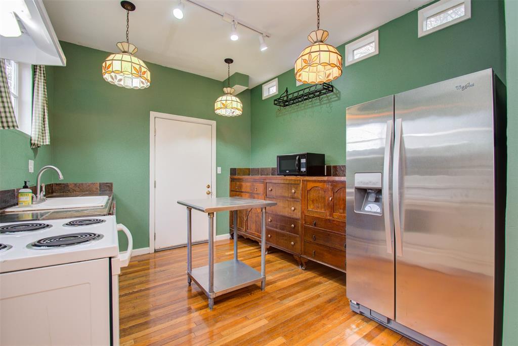 a kitchen with cabinets a refrigerator and a table