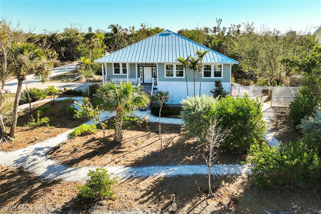 a view of a house with a yard and sitting area