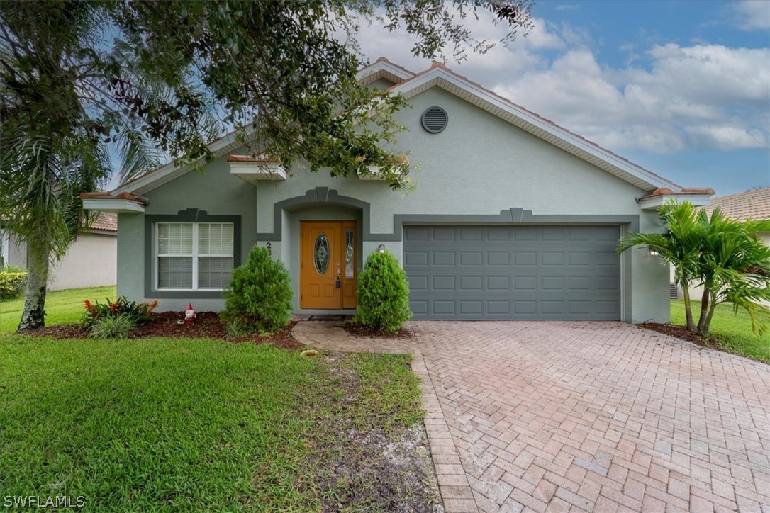 a front view of a house with a yard and garage