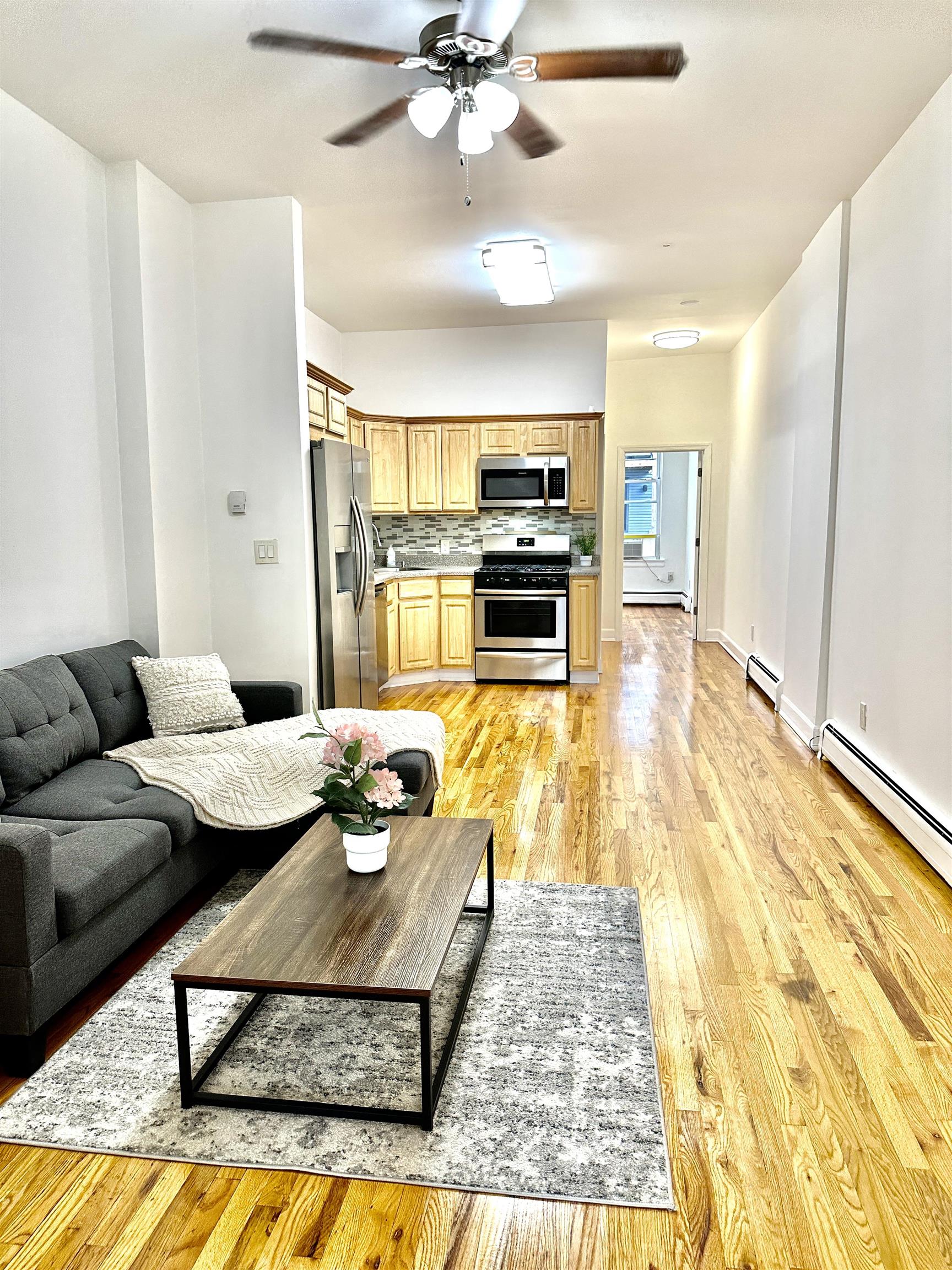 a living room with furniture and kitchen view