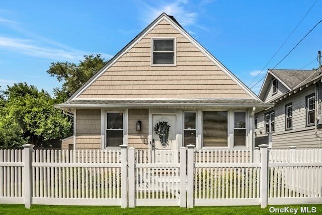 a view of a white house with a small deck