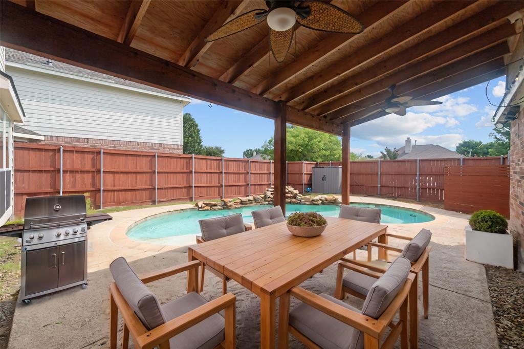 a view of a dining table and chairs in the patio