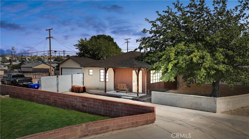 a view of a house with entertaining space and a tree