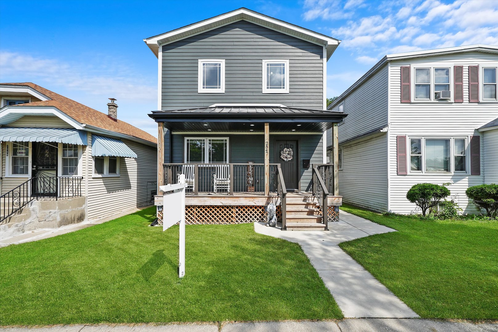 a view of a house with a yard and sitting area