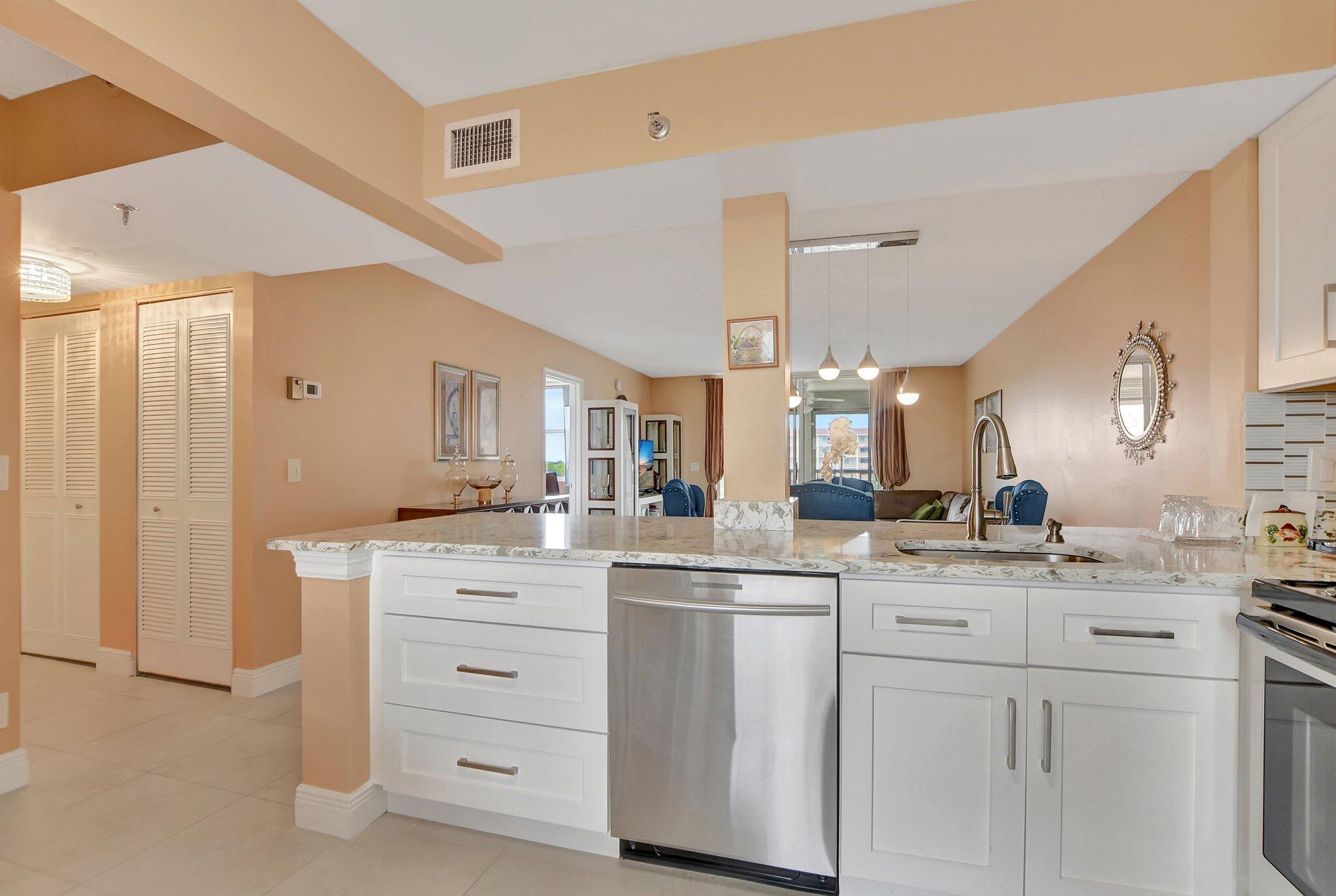 a kitchen with a white cabinets and sink