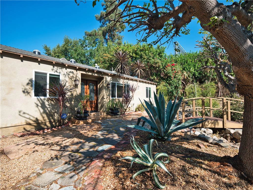 a view of a house with a tree in the background