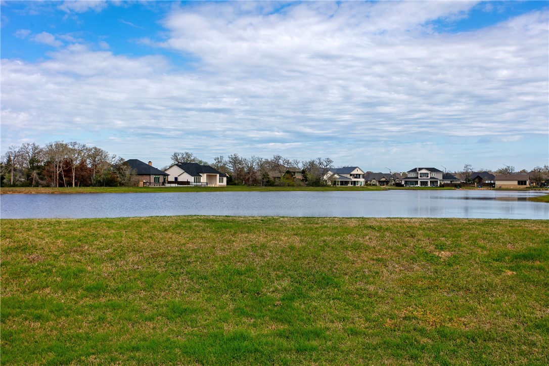 a view of a lake with houses in the back