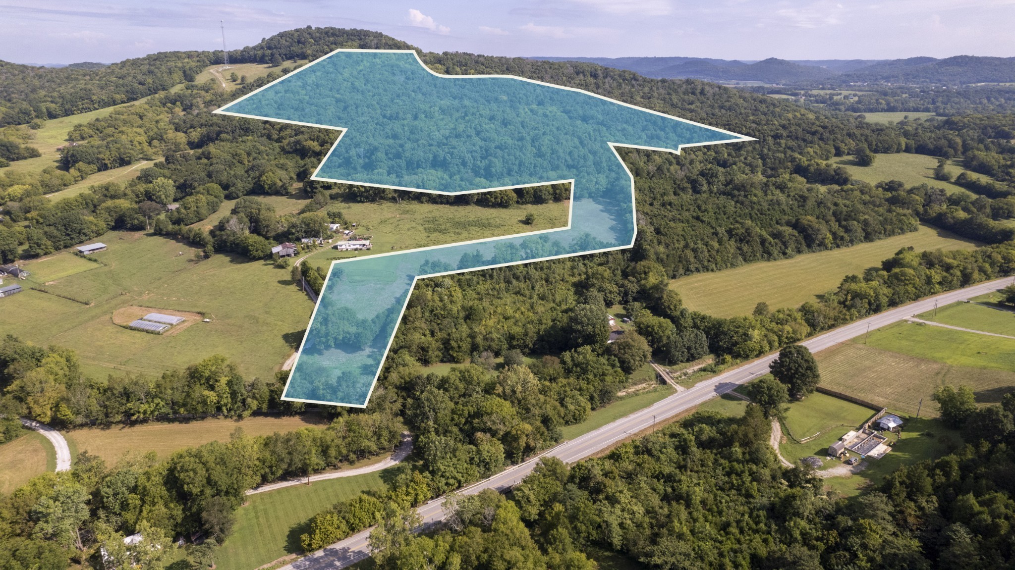 an aerial view of a house with a mountain