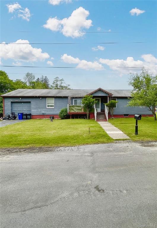 a view of a house with a swimming pool and a yard