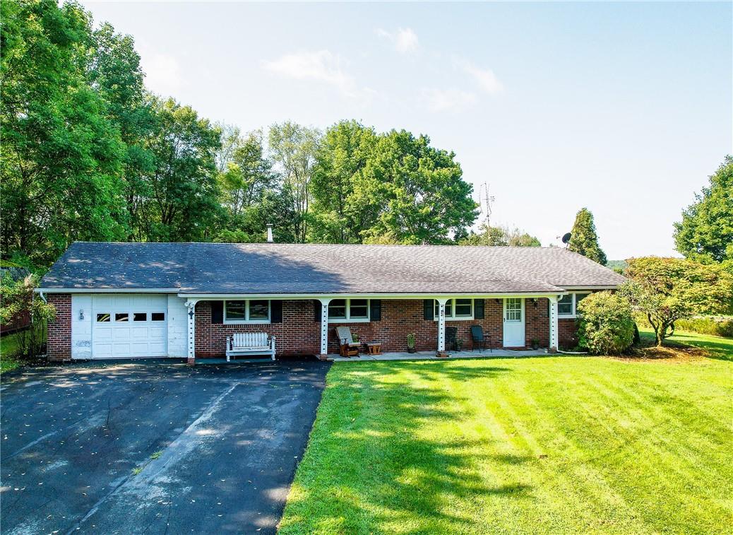 Ranch-style house with a front lawn and a garage