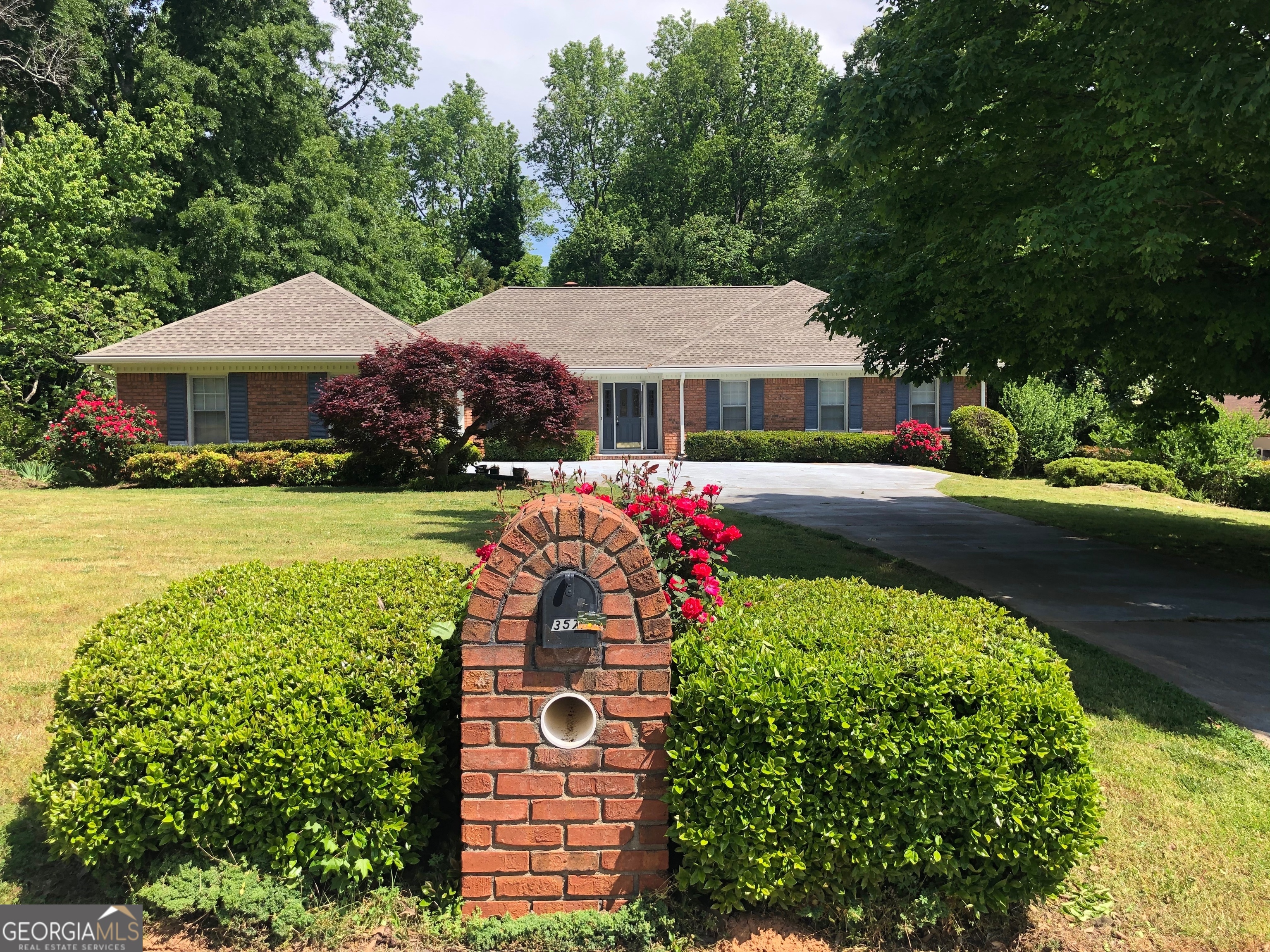 a front view of house with yard and green space