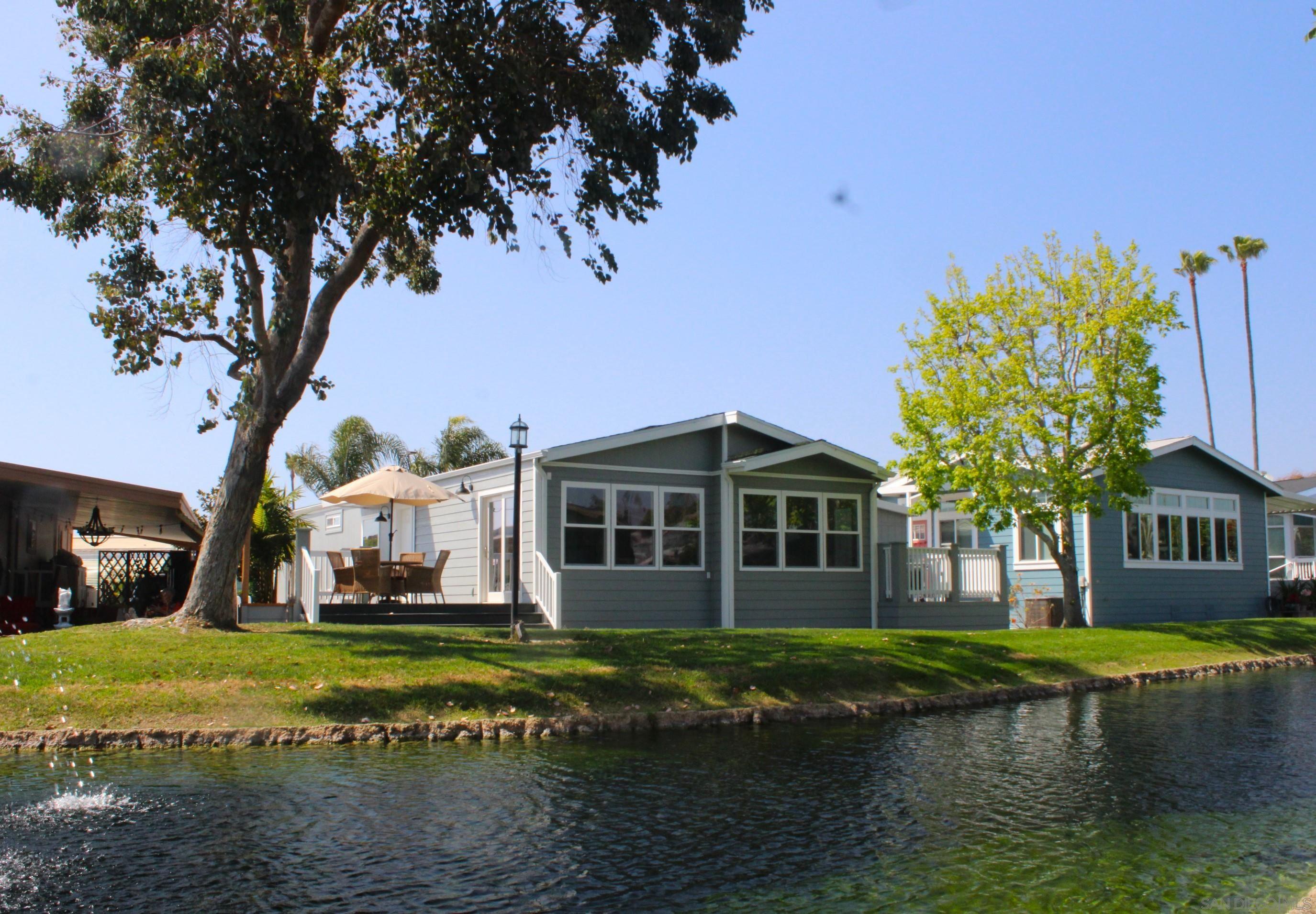 a front view of a house with a garden and trees