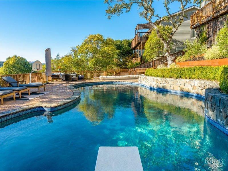 a view of swimming pool with outdoor seating and yard