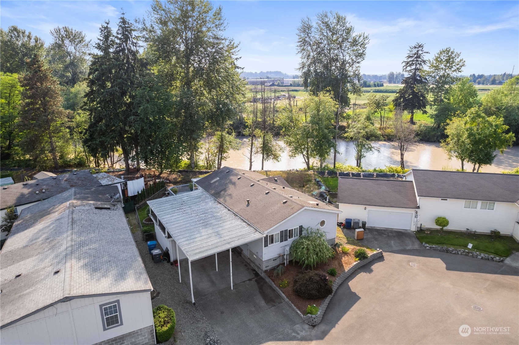 an aerial view of a house with garden space and street view