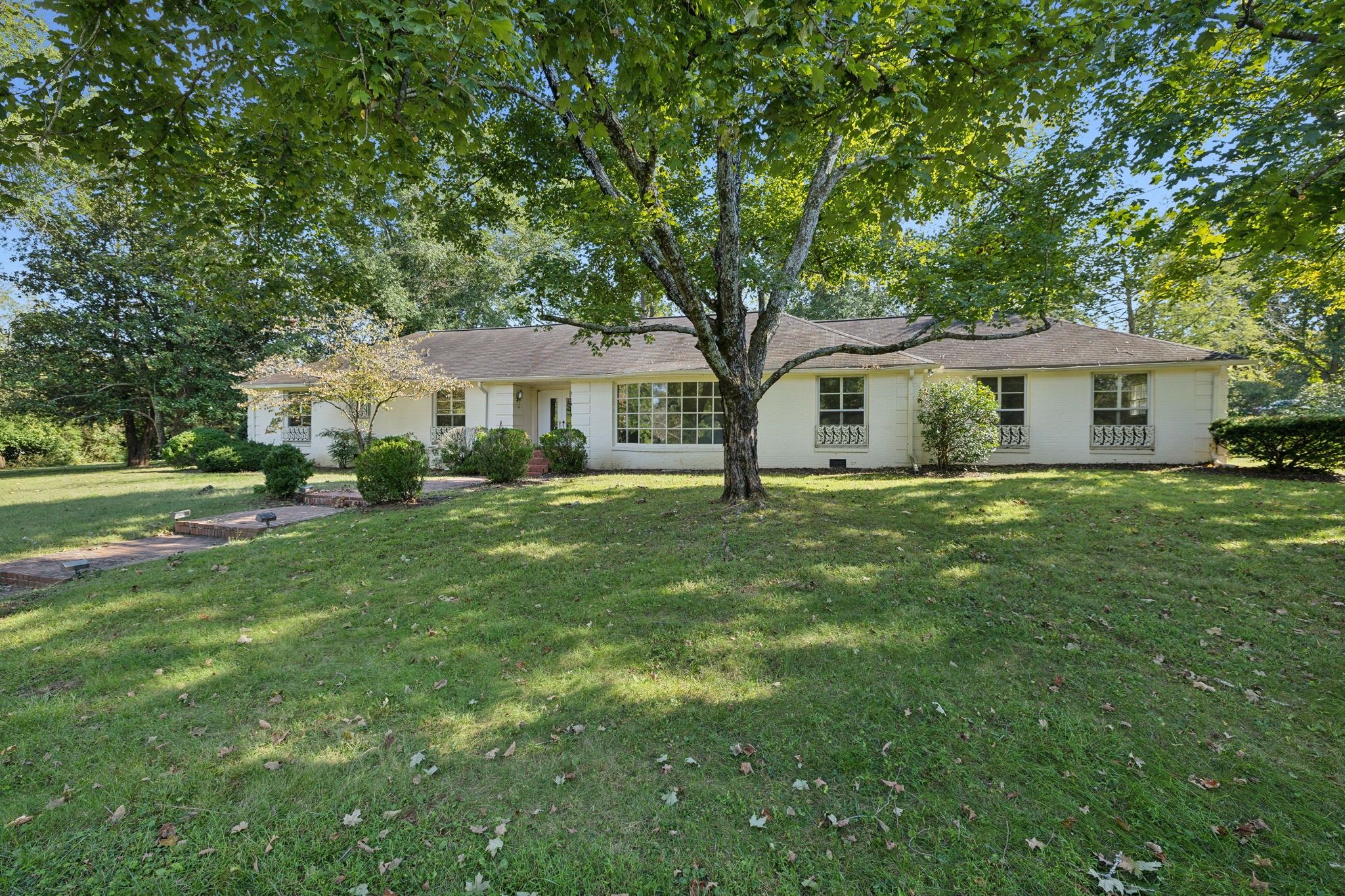 a front view of a house with a garden