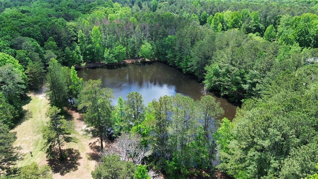 an aerial view of a house with a yard and lake view