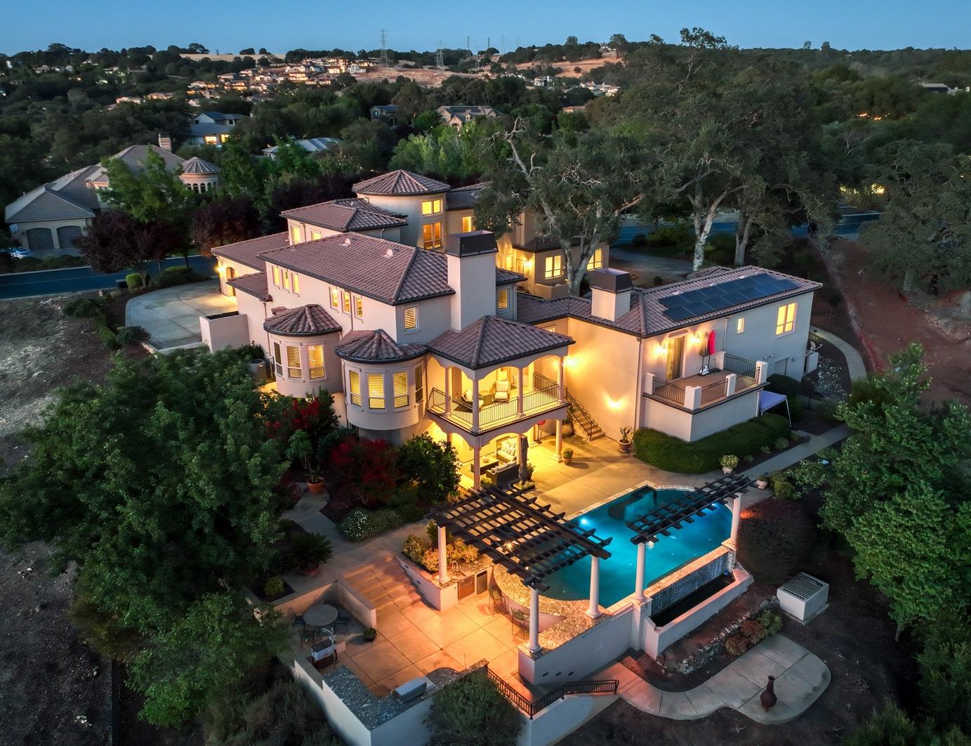 an aerial view of residential houses with outdoor space and trees