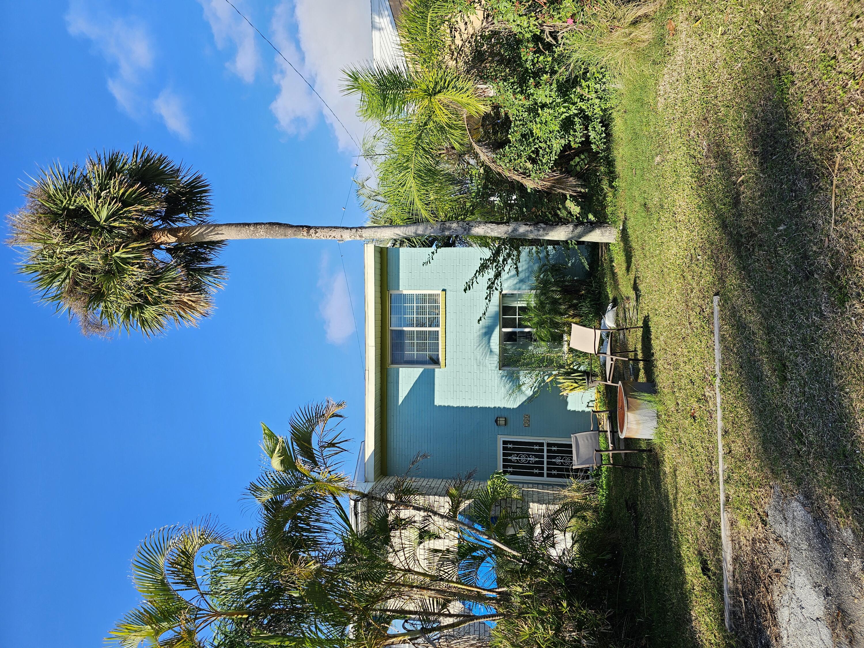 a view of a house with backyard porch and sitting area