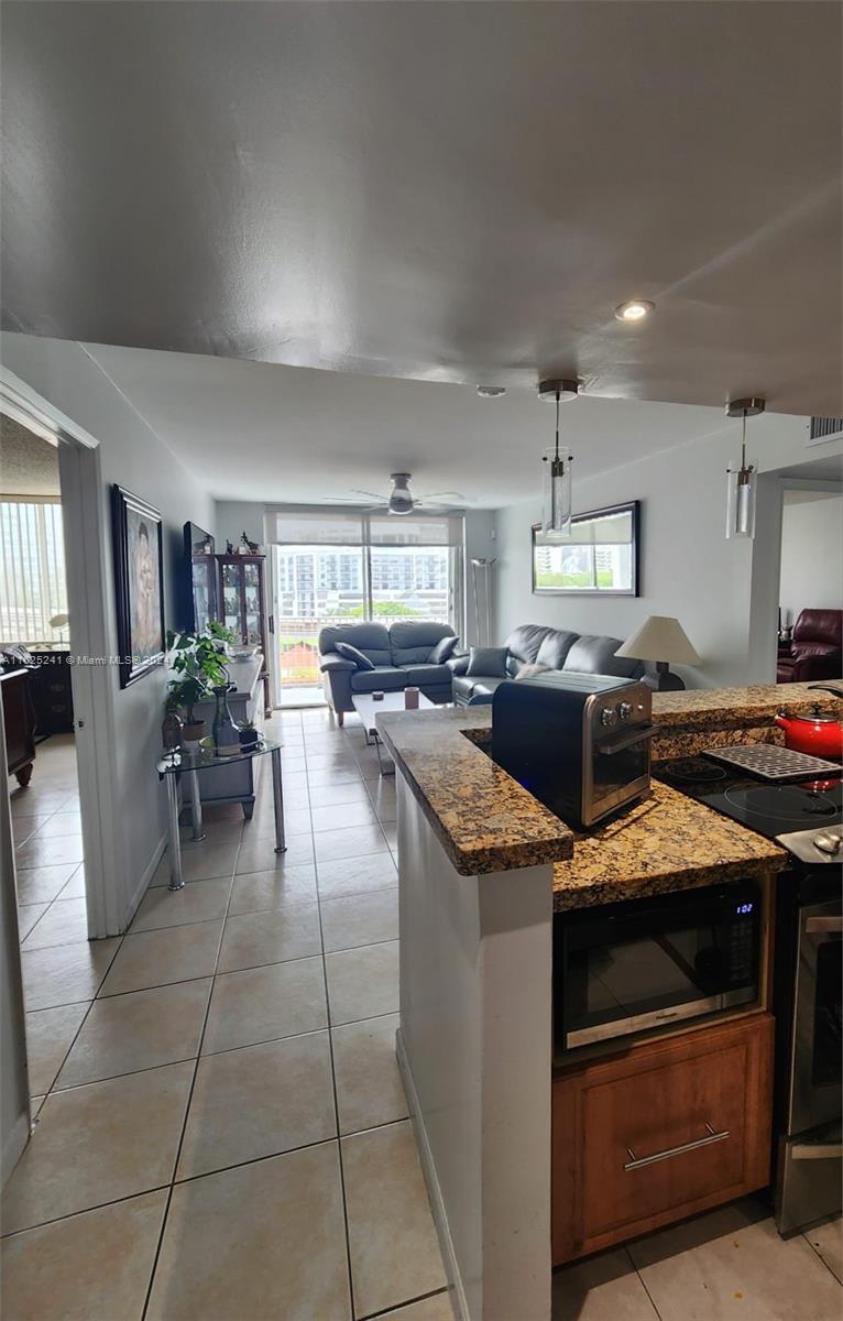 a kitchen with kitchen island granite countertop lots of counter top space and appliances