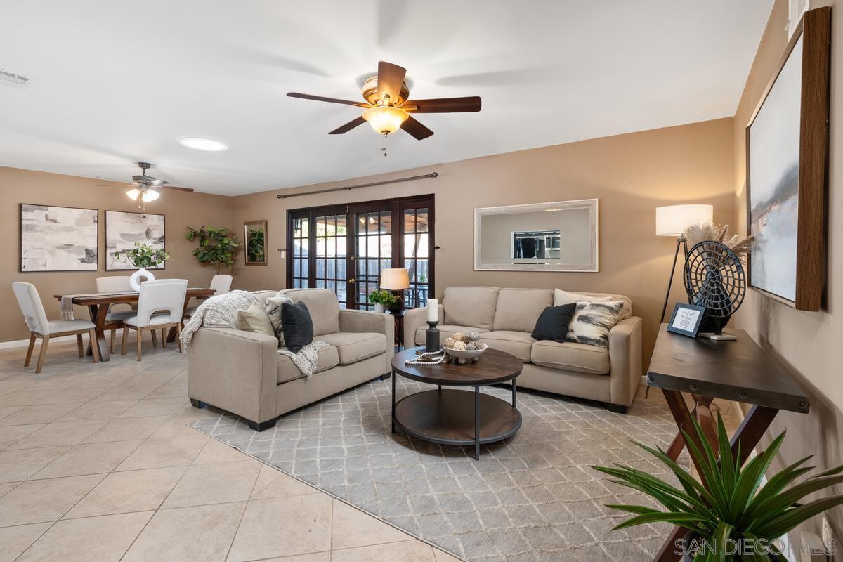 a living room with furniture ceiling fan and a rug