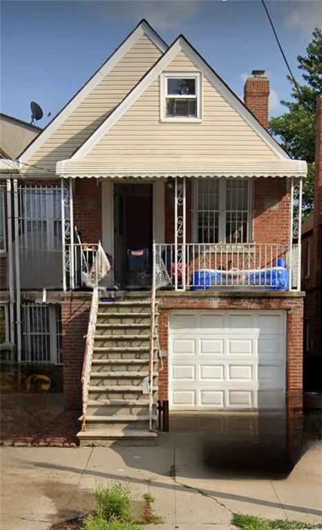 View of front of house with a porch and a garage