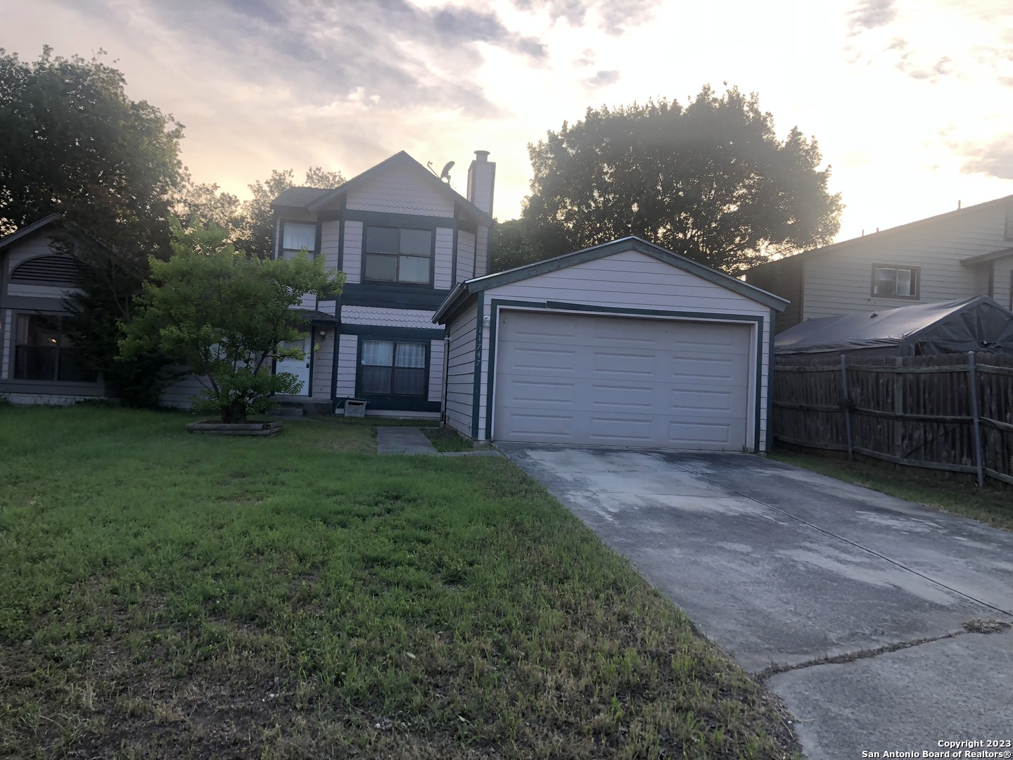 a front view of a house with a garden and yard