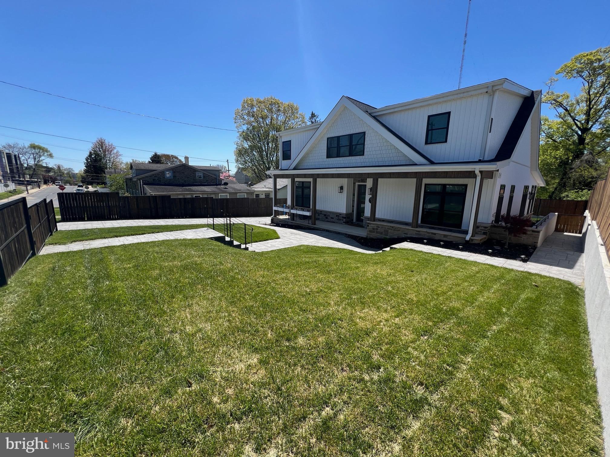 a view of a house with pool and a yard