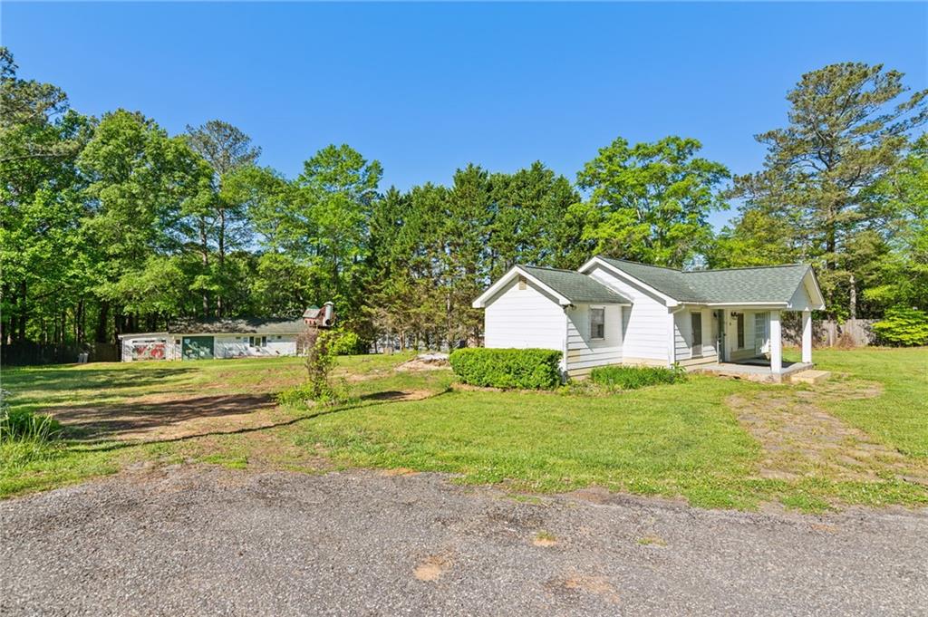 a front view of a house with a yard and trees