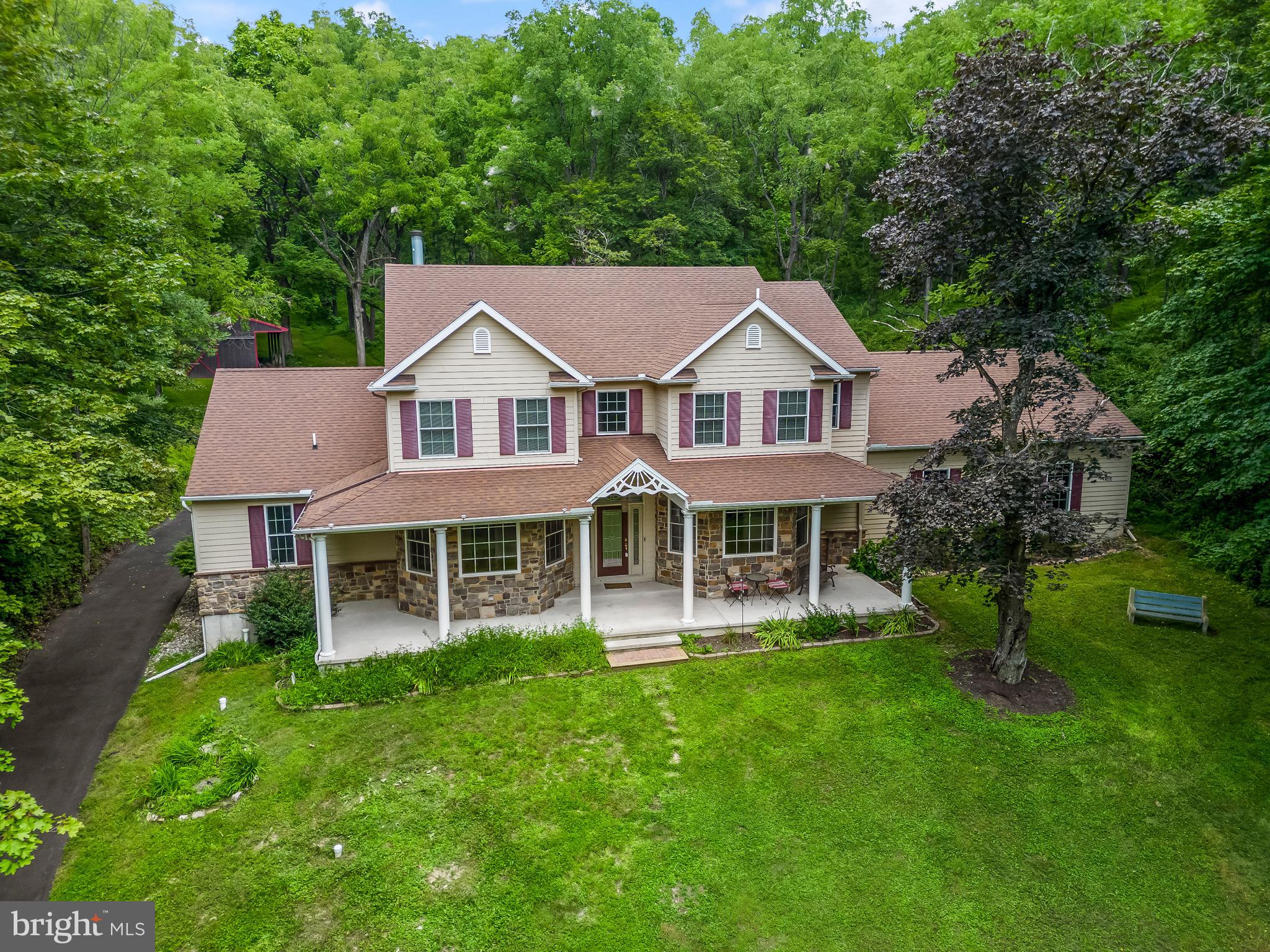 a aerial view of a house with a yard table and chairs