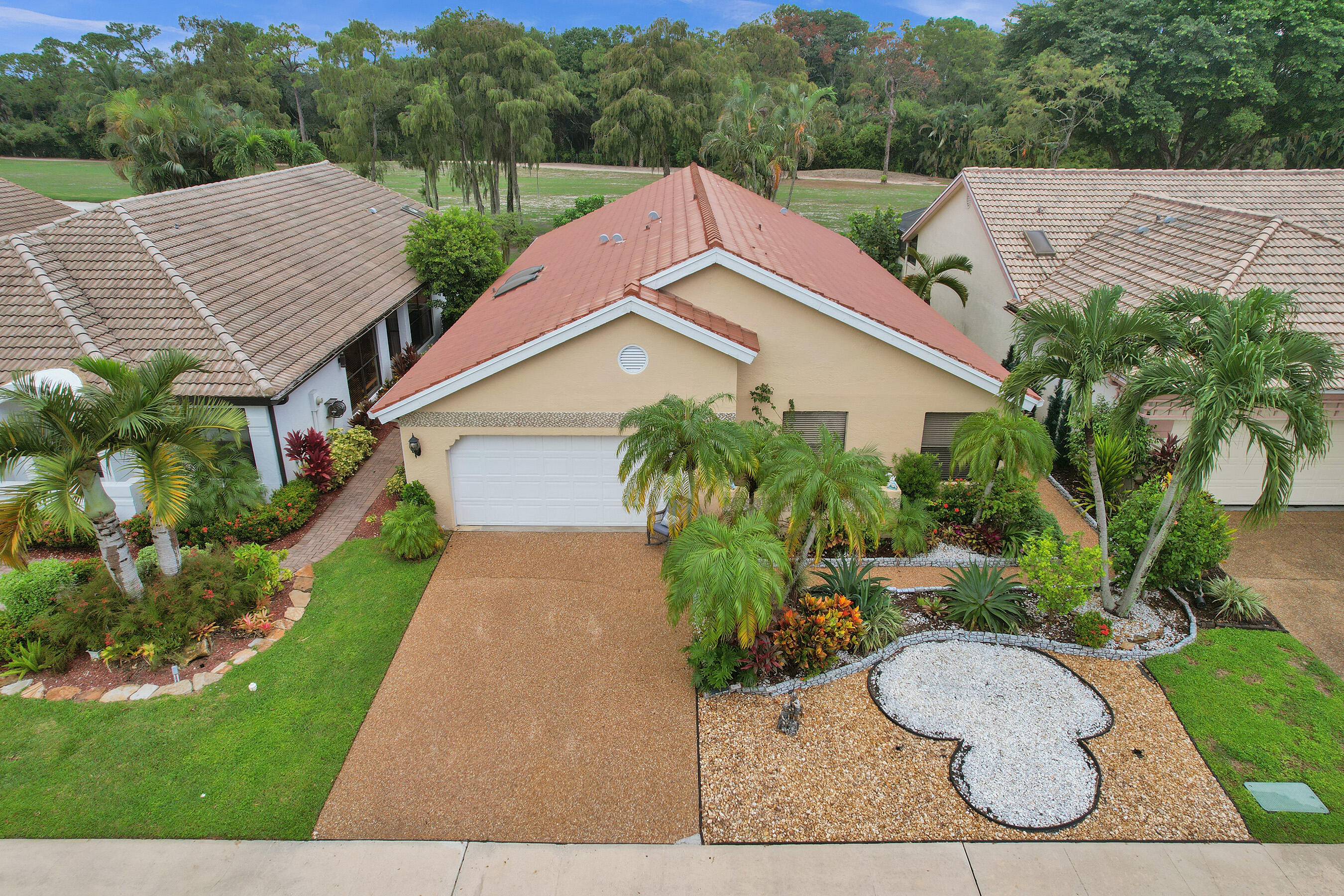 a aerial view of a house with a yard and potted plants