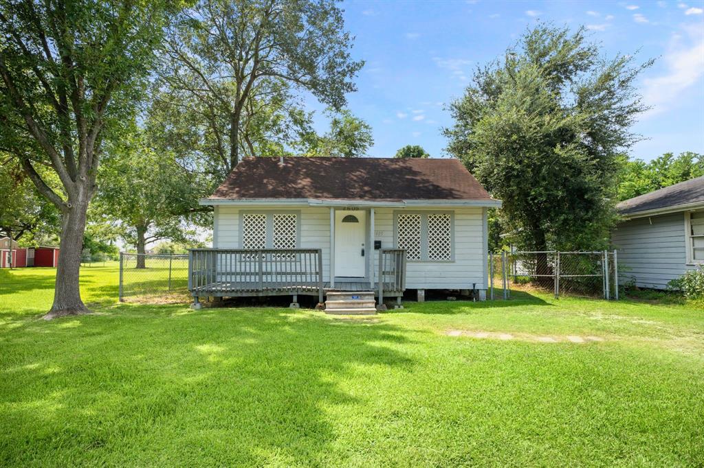 a view of a house with a yard and sitting area