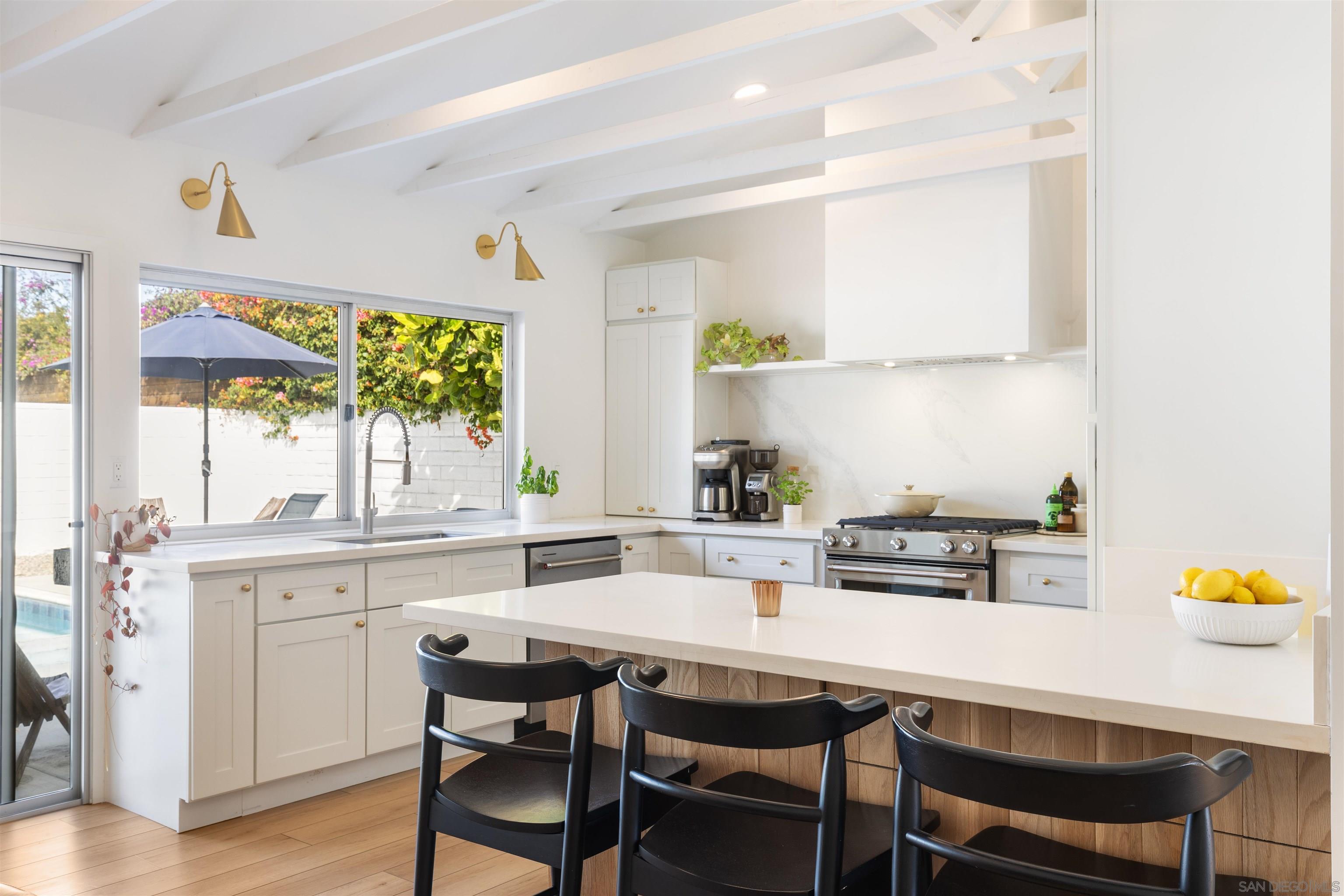 a kitchen with a dining table and chairs