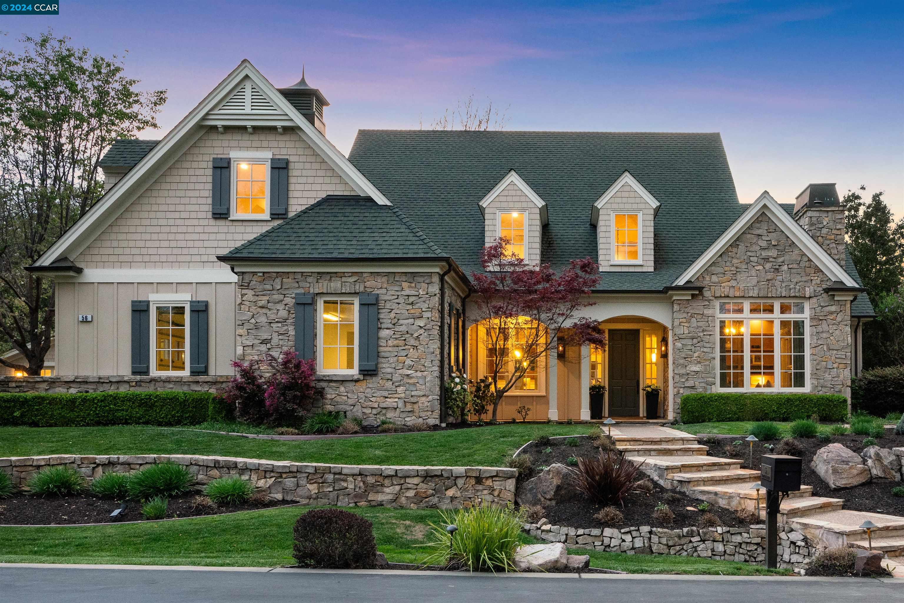 a front view of a house with garden