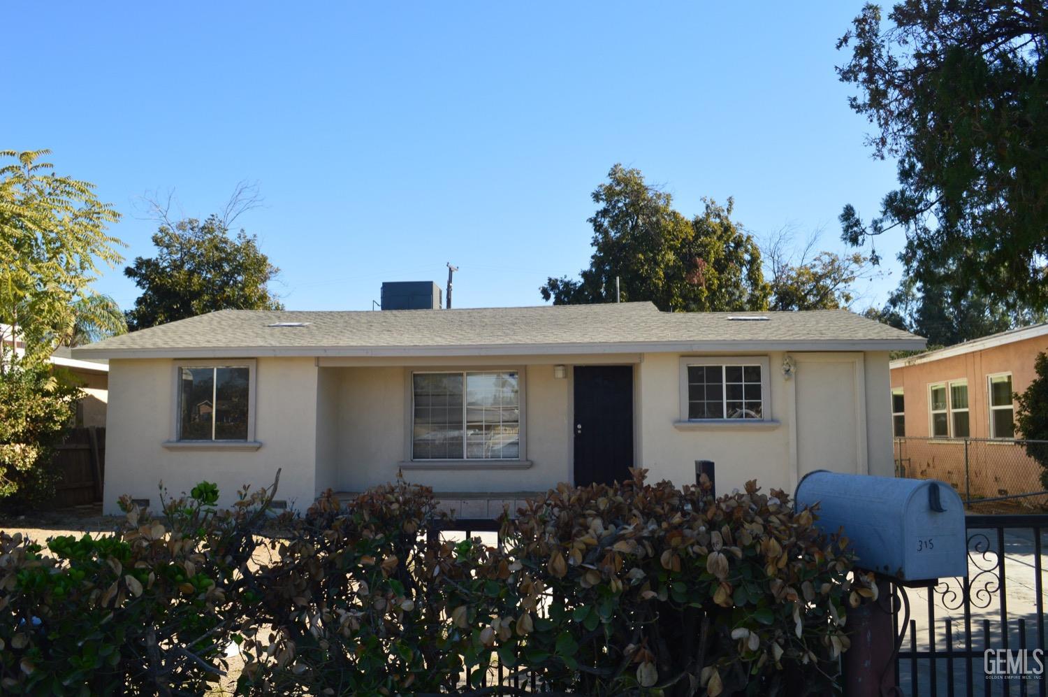 a front view of house with yard and outdoor seating