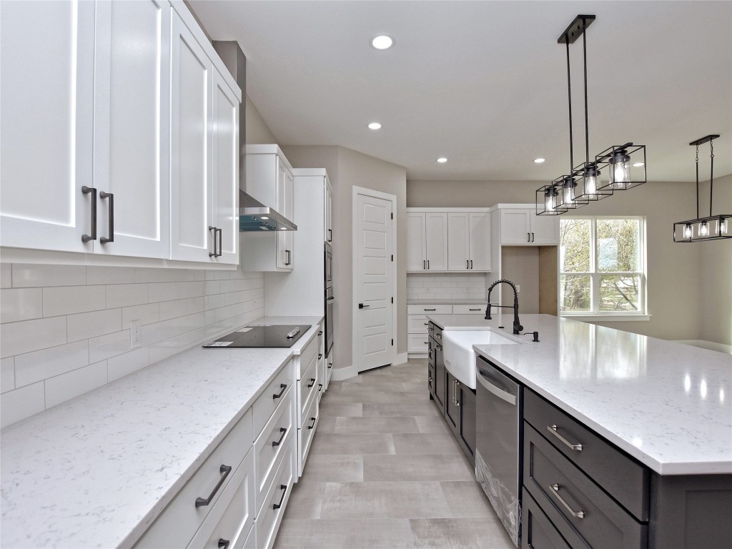 a kitchen with white cabinets appliances and a sink