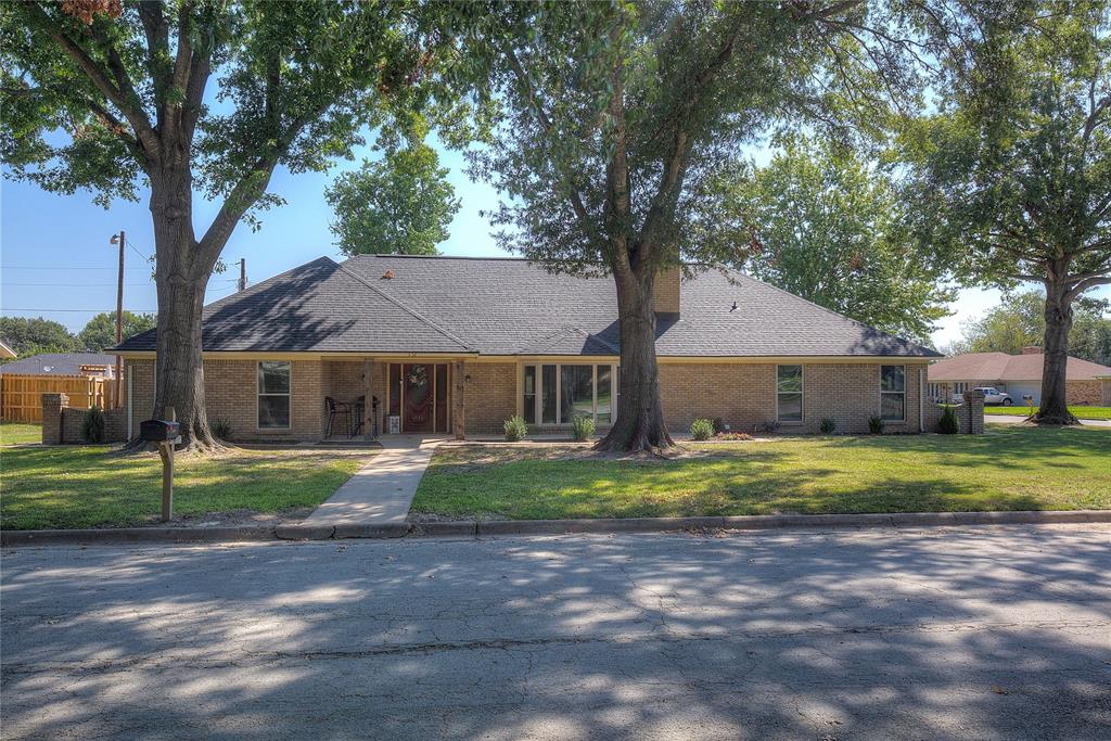 a house that has a tree in front of it