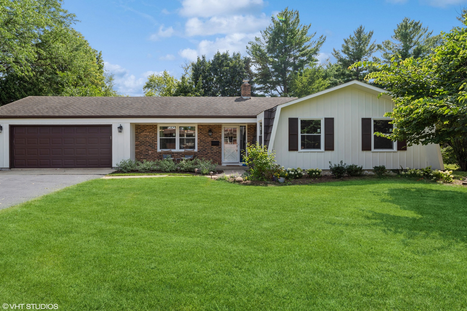 a front view of house with yard and green space