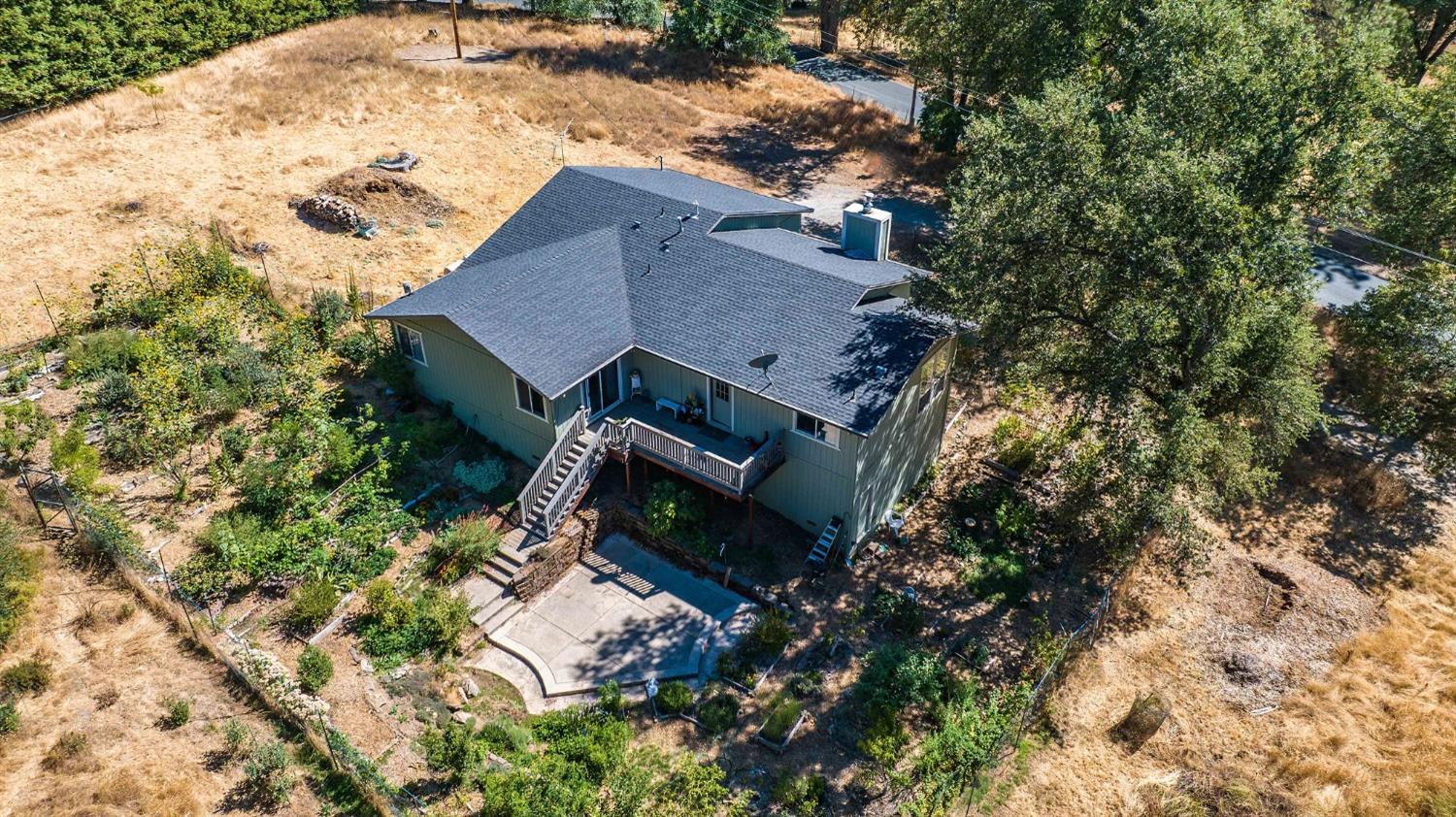 a aerial view of a house with a yard and sitting area