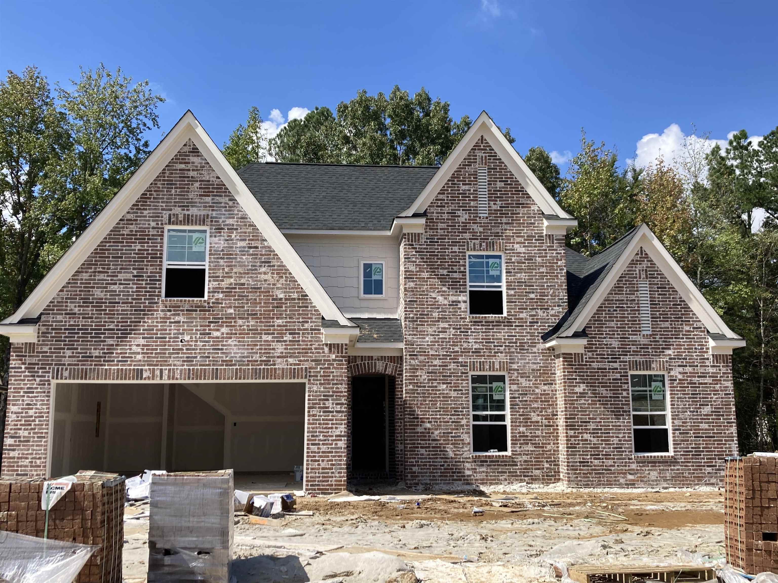 a front view of a house with yard