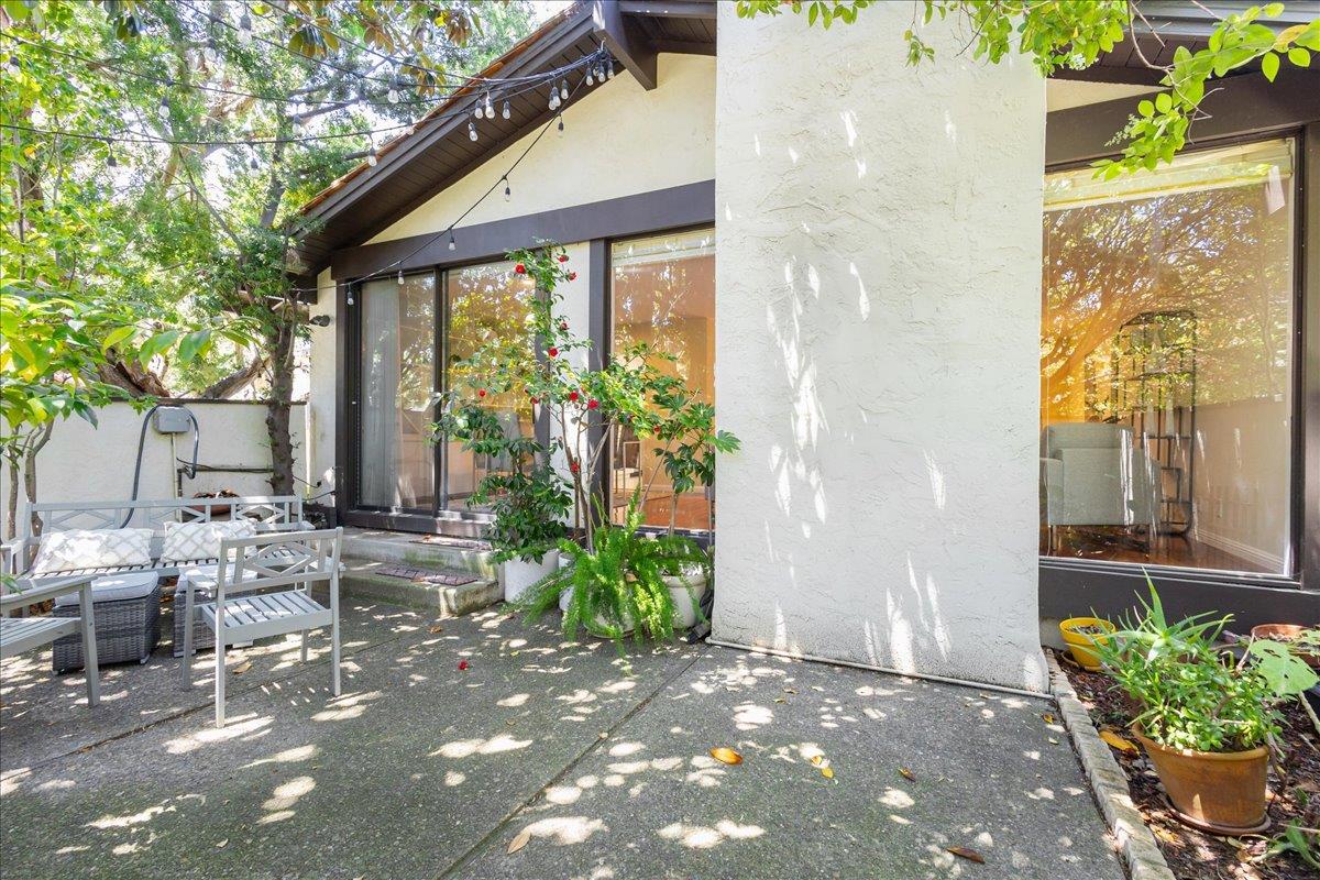 a backyard of a house with outdoor seating