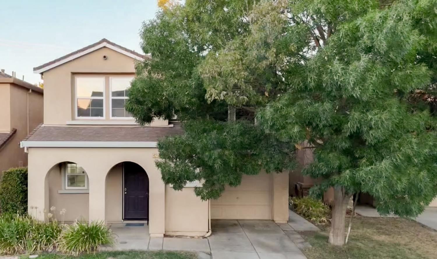 a front view of a house with plants