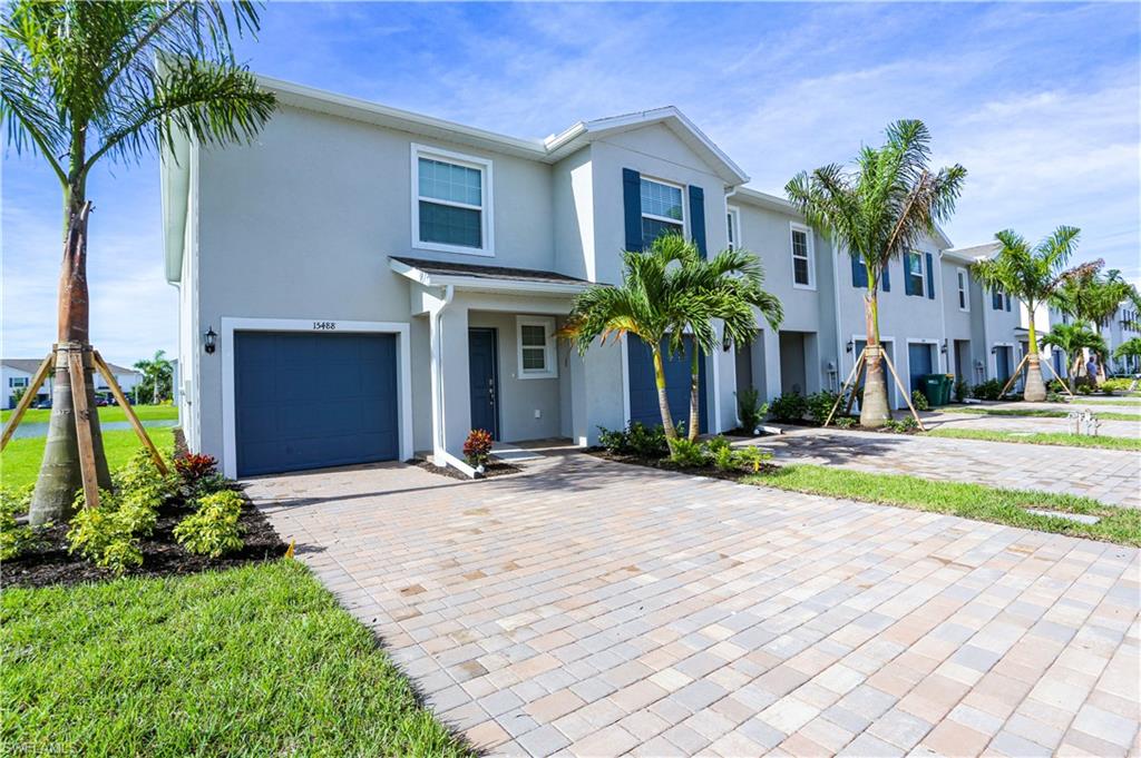 a front view of a house with a yard and garage