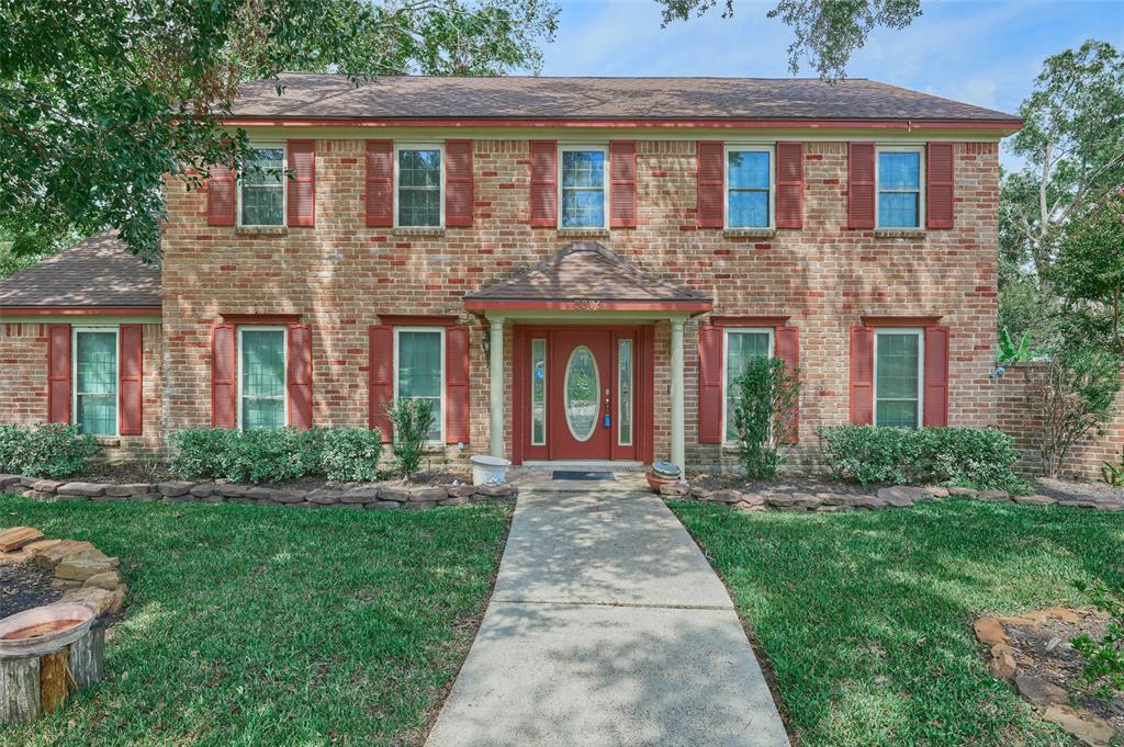 a front view of brick house with a yard