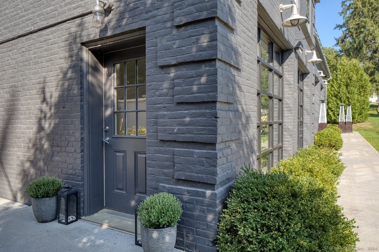 a brick building with a small yard