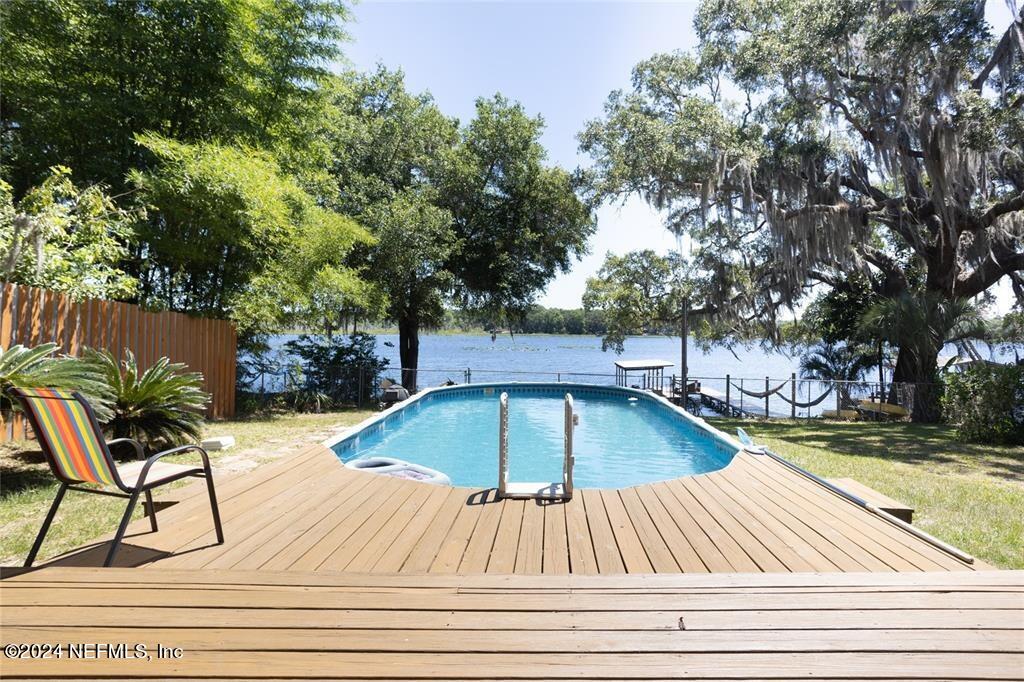 a view of swimming pool with sitting area and furniture